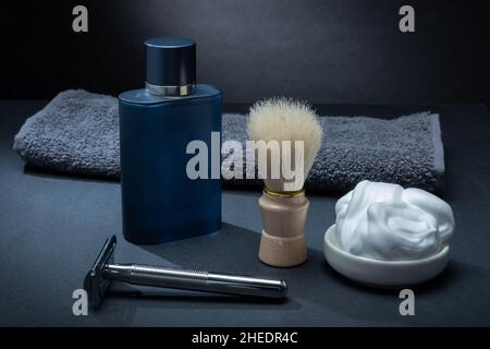 Helsinki / Finland - JANUARY 10, 2022: Closeup of men's toilet accessories: a razor, a shaving brush, and some shaving foam. Stock Photo