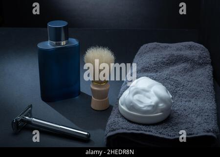 Helsinki / Finland - JANUARY 10, 2022: Closeup of men's toilet accessories: a razor, a shaving brush, and some shaving foam. Stock Photo