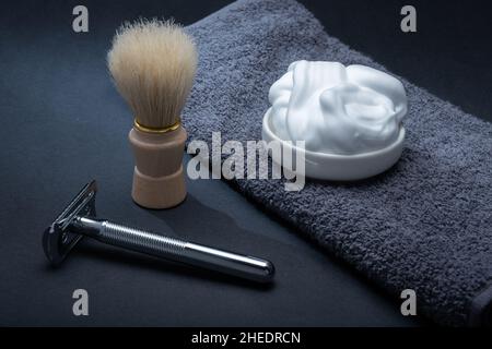 Helsinki / Finland - JANUARY 10, 2022: Closeup of men's toilet accessories: a razor, a shaving brush, and some shaving foam. Stock Photo