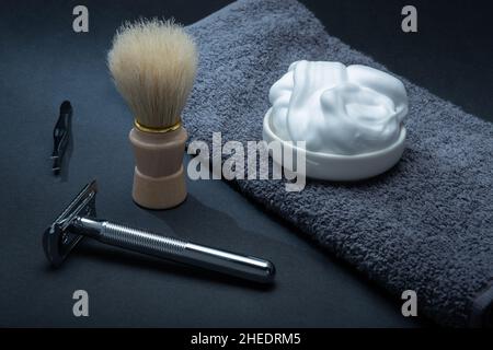 Helsinki / Finland - JANUARY 10, 2022: Closeup of men's toilet accessories: a razor, a shaving brush, and some shaving foam. Stock Photo