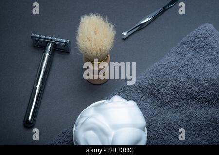 Helsinki / Finland - JANUARY 10, 2022: Closeup of men's toilet accessories: a razor, a shaving brush, and some shaving foam. Stock Photo