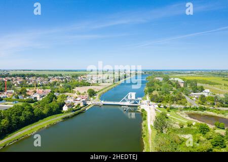 This landscape photo was taken in Europe, France, Normandy, towards Caen, Ranville, in summer. We see The Pegasus Bridge on the Orne Canal, under the Stock Photo