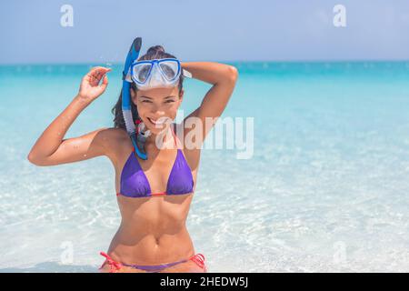 Snorkeling watersport recreational activity happy Asian woman wearing snorkel mask for underwater swim in Caribbean ocean on beach vacation travel Stock Photo