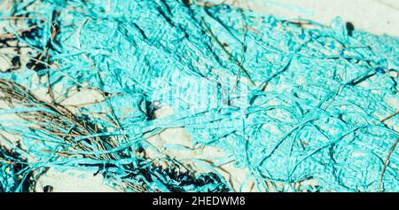BANNER abstract beauty background. Copy space soft bag cloth rag fabric flap texture surface material on sand ground. Turquoise light blue colour Stock Photo