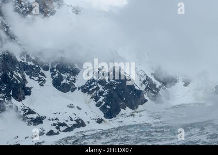 Aiguille du Midi peak between clouds, mountain in the Mont Blanc massif ...