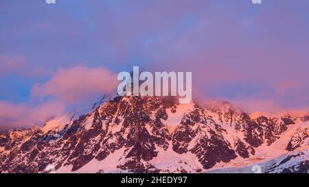 This landscape photo was taken in Europe, in France, in the Alps, towards Chamonix, in summer. We can see the pink clouds around the Aiguille du Midi