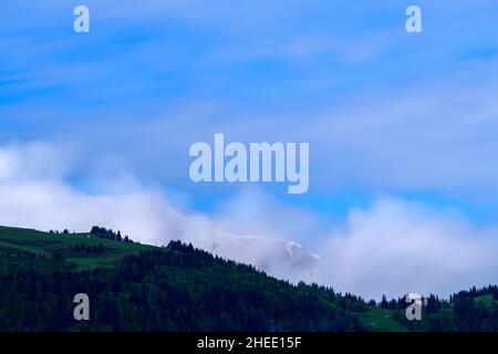 This landscape photo was taken in Europe, in France, in the Alps, towards Chamonix, in summer. We see the clouds moving around Mont Joly and the Col d
