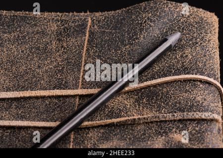 Black pencil on a leather-bound diary Stock Photo