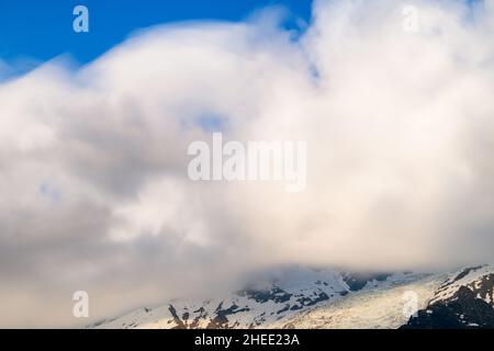 This landscape photo was taken in Europe, in France, in the Alps, towards Chamonix, in summer. We can see the clouds moving around the Aiguille du Mid