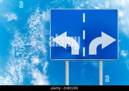 Road sign with opposite arrows on two rod Stock Photo