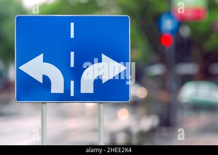 Road sign with opposite arrows on two rod Stock Photo