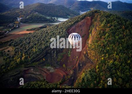 On balloon over Croscat volcano in Garrotxa Natural Park and mountains on the background in Garrotxa Olot Girona province Catalonia, Spain.  Vol de Co Stock Photo