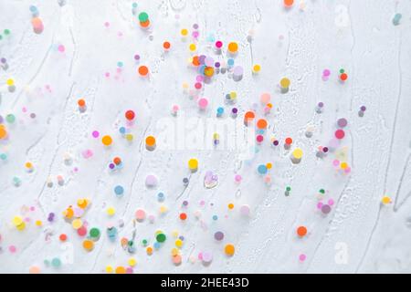 Abstract rainbow colored glitter particles. Macro Stock Photo