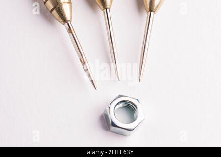 Three arrows dart tips on white with text space with screw fastener Stock Photo