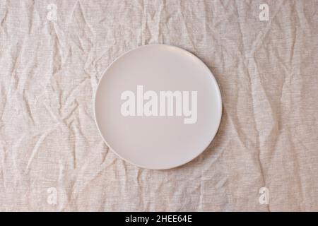 White colored circle shaped ceramic plate on isolated background, food mockup Stock Photo