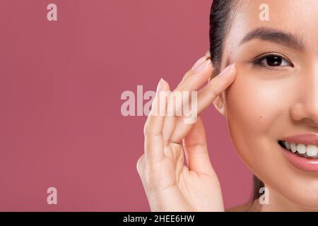 Half face of korean lady enjoying her beauty routine Stock Photo