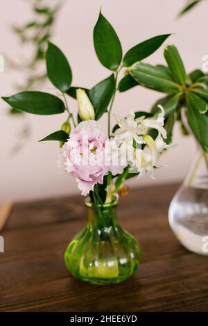 Pink eustoma and white hyacinth flowers in a glass vase in the decor of the house or table Stock Photo