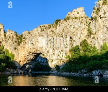 This landscape photo was taken in Europe, France, Ardeche, summer. We can see Le Pont dArc in the gorges of the Ardeche, under the Sun. Stock Photo