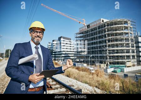 senior businessman architect helmet construction site building architecture Stock Photo