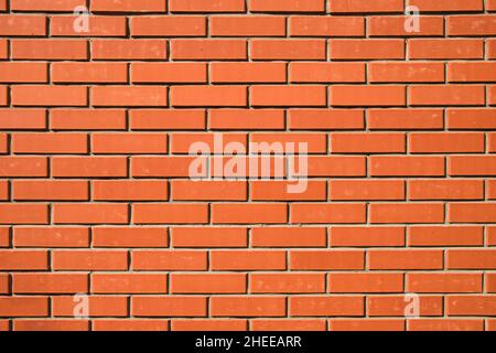 Red brick wall. Background of a new brick house. Perfect smooth brickwork. Great construction concept. Stock Photo