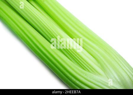 Close-up of celery stalks on white background. Fresh green vegetables. Organic and diet concept. Stock Photo