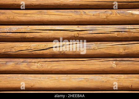 Wooden log wall texture background. Closeup wall of old wooden house. Stock Photo