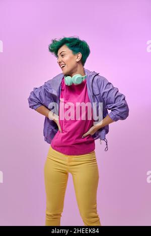 Crop anonymous male guitarist playing electric guitar in club with neon blue lights Stock Photo