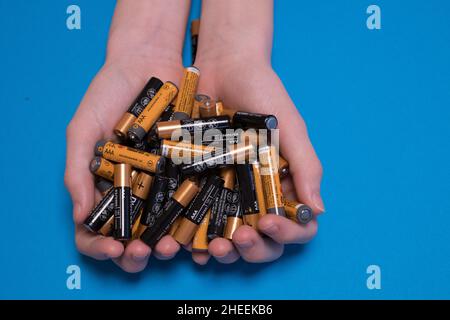 many small batteries are in the hands Stock Photo