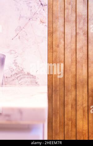 Purple ornament on white wall with marble shelf near wooden wall in stylish apartment Stock Photo