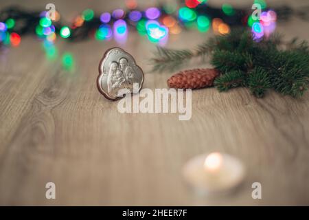 Christmas Composition of Candle on a Wooden Background With colorful Light Stock Photo