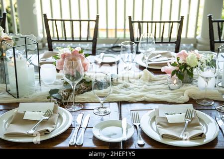 Table set up for outdoor wedding reception with elegant decor. Stock Photo