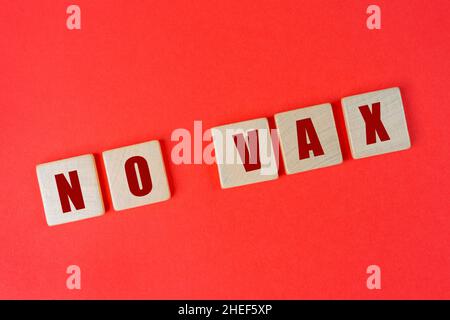 the phrase No vax written on a red surface Stock Photo