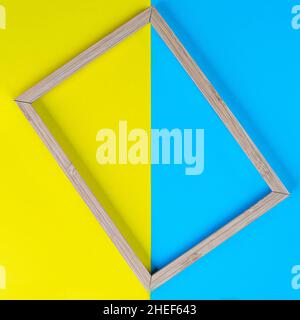 a wooden frame on a background of colored shapes Stock Photo