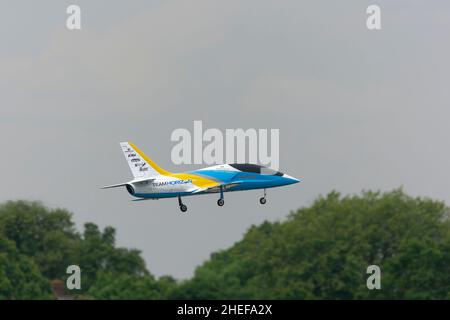 Model airplane in flight in the sky Stock Photo