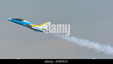 Model airplane in flight in the sky with smoke trail Stock Photo