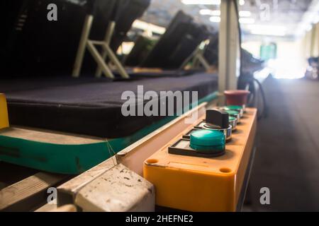 Control buttons installed at line conveyor for TV assembly line. Stock Photo
