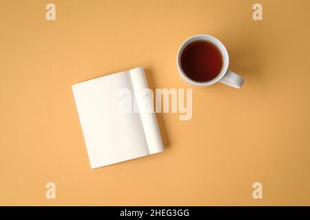 Flat lay of notepad and coffee on yellow tabletop. Copy space. Stock Photo