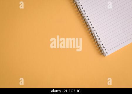 Blank notepad on yellow background. Copy space. Stock Photo