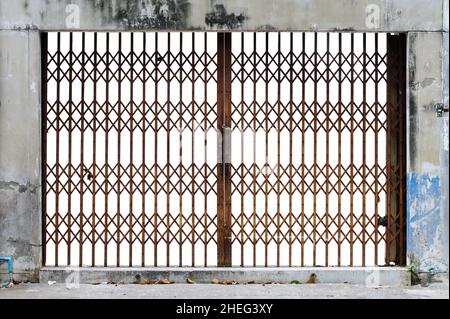 Antique slide steel door locked on white background Stock Photo