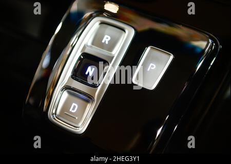 Modern gearbox control button on a central console in a new car Stock Photo