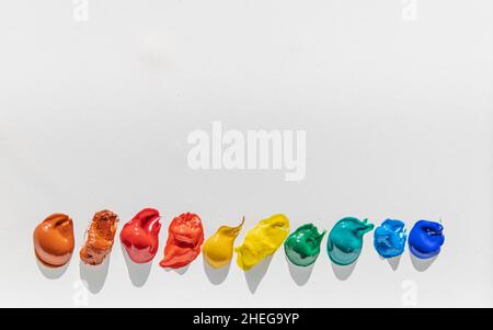 Paint in colors of rainbow on bottom of white background with text space Stock Photo