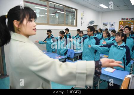 GUIYANG, CHINA - JANUARY 11, 2022 - A music teacher instructs students to practice traditional Opera desk exercises in Guiyang, Guizhou Province, Chin Stock Photo