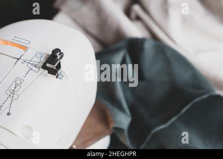 Sewing machine on a table in a sewing workshop, top view Stock Photo