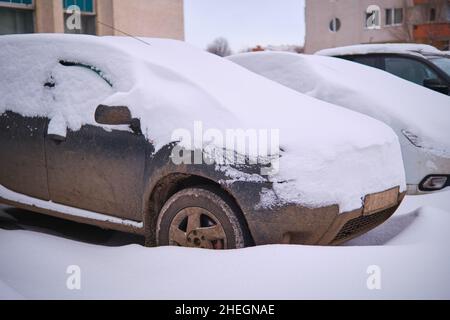 Parked cars completely covered with snow after snowfall Stock Photo