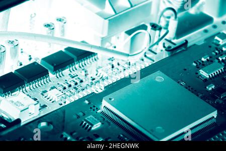 Electronic circuit board. Semiconductor motherboard circuit board technology. Mainboard of computer. Integrated semiconductor microchip on green Stock Photo