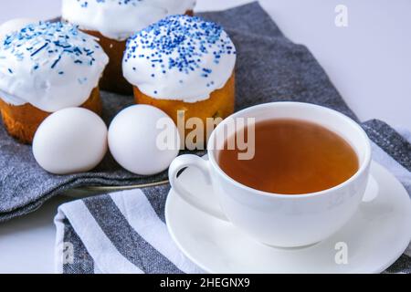 Cup of tea. Happy Day Bright Easter. Orthodox Easter holiday. Traditional food. Creative stylish trend Homemade easter cake. Selective focus Stock Photo