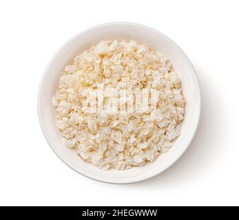 Bowl of rice flakes isolated on white background, top view Stock Photo