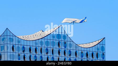 Hamburg, Germany. 06th Jan, 2022. An Airbus A300-600ST, colloquially known as Beluga, flies over Hamburg's city center with the Elbe Philharmonic Hall in the foreground during its approach to Finkenwerder Airport. Credit: Markus Scholz/dpa/Alamy Live News Stock Photo
