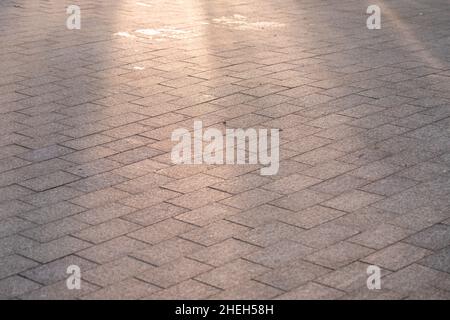Pavement, the cobbles, stone sett surface, paving in the old town in Poznan, in the winter sun. Stock Photo