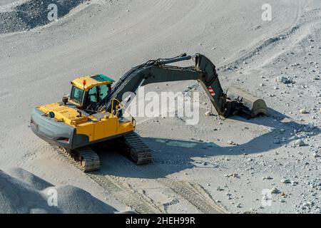 VALLDAL, NORWAY - 2020 JUNE 03. Yellow and black excavator at a construction site Stock Photo